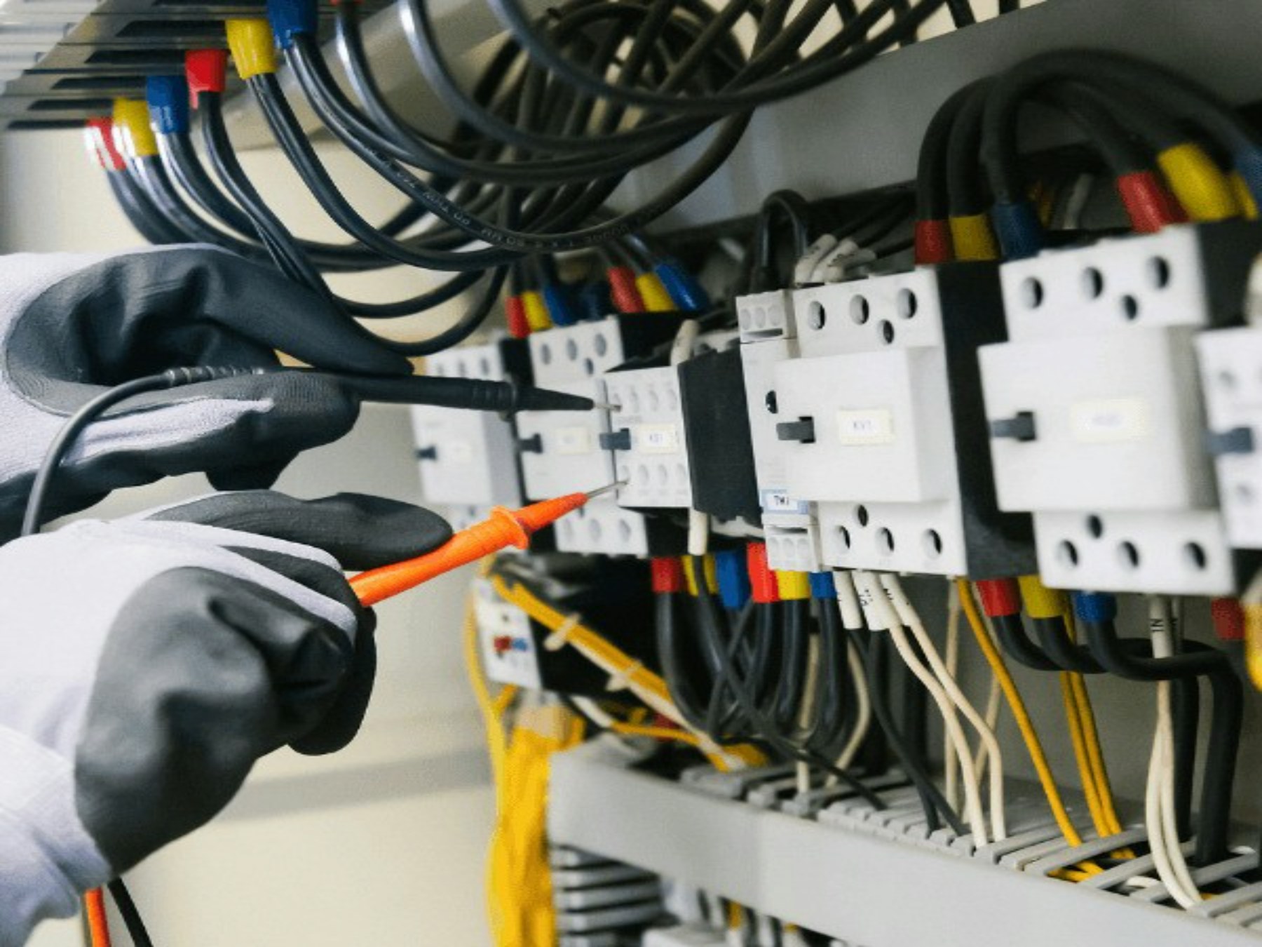 Electrician testing an electrical distribution panel